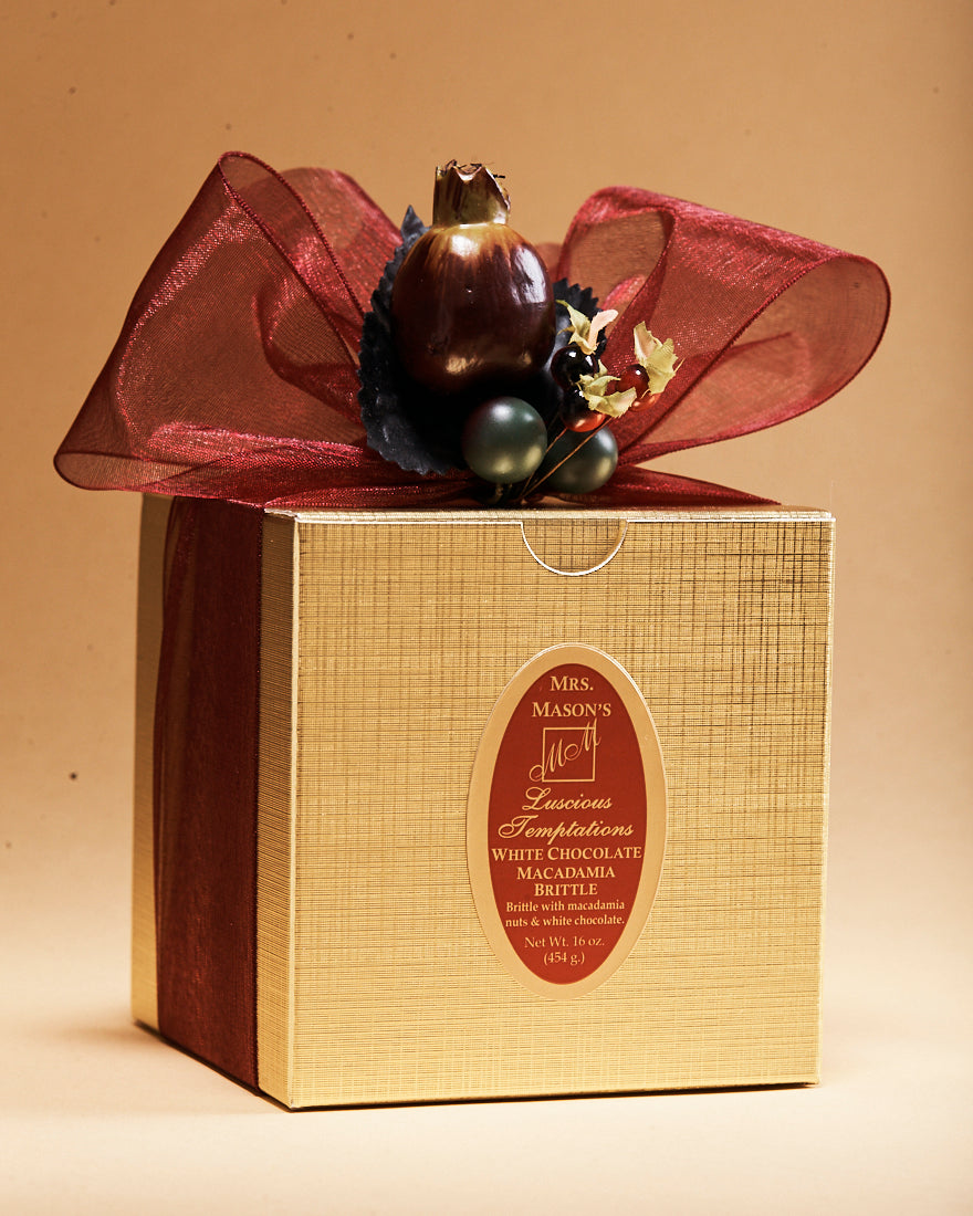 White Chocolate Macadamia Brittle in one pound gold gift box in Fall wrap